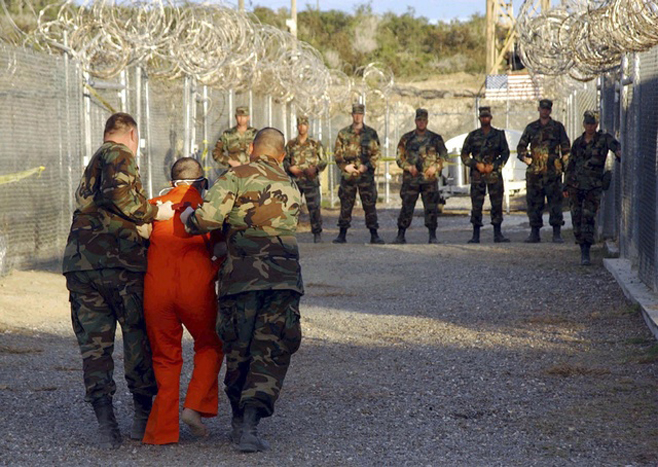 File photo of U.S. Army Military police escorting a detainee to his cell in Naval Base Guantanamo Bay